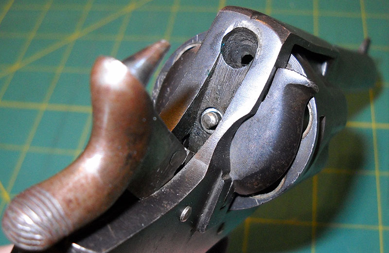 detail of cocked hammer, showing fixed firing pin and the hole in the frame it goes into